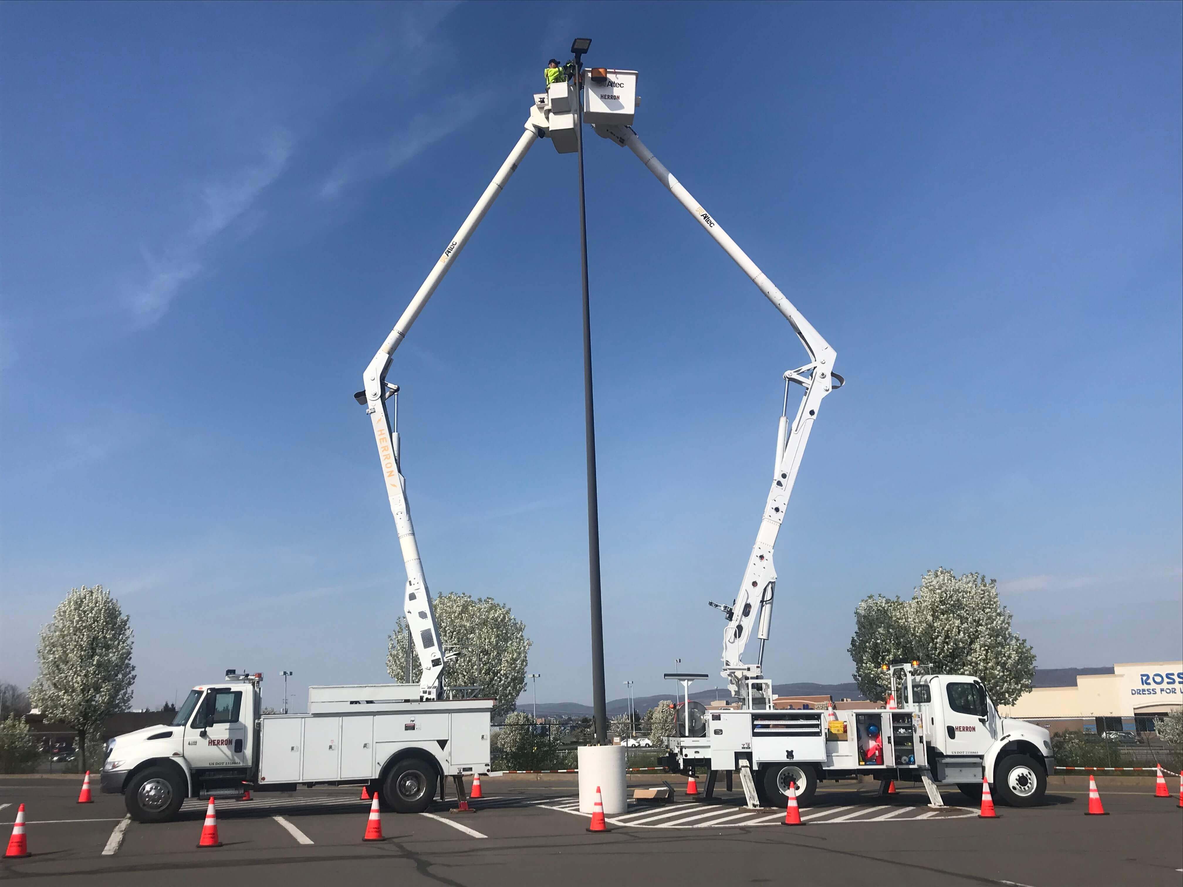 Herron Electric trucks working on a digital sign